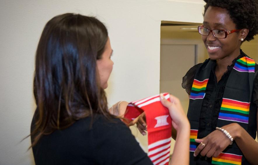 Teacher awarding student with a ceremonial scarf