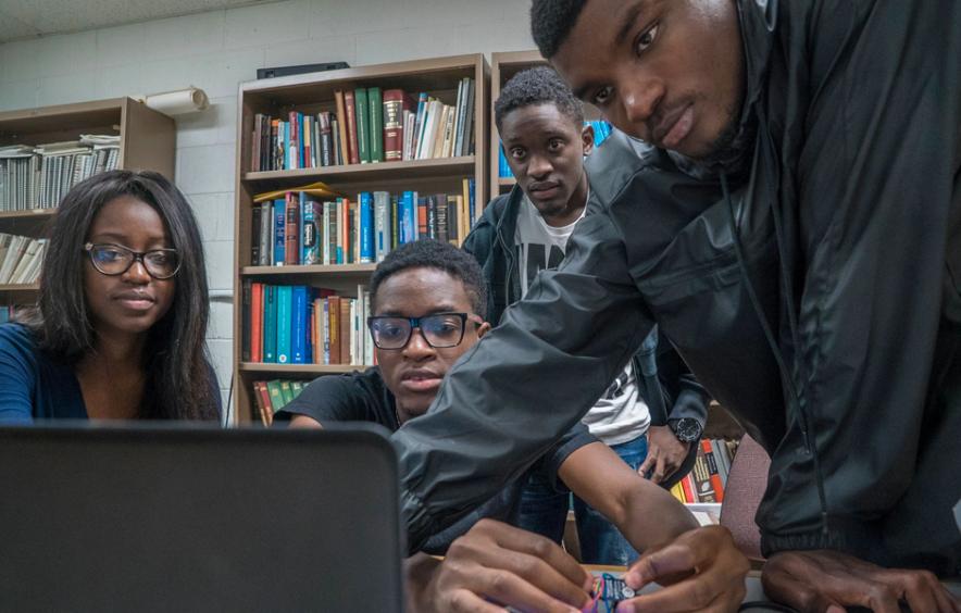 students looking at computer