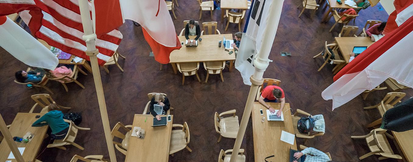 overhead view of people studying in the library with flags in the foreground