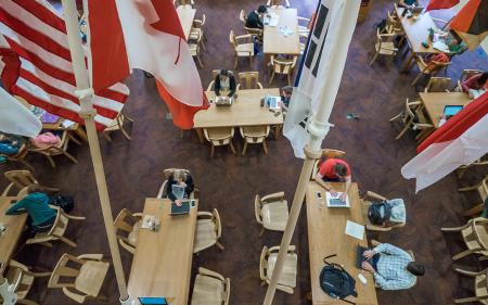 overhead view of people studying in the library with flags in the foreground